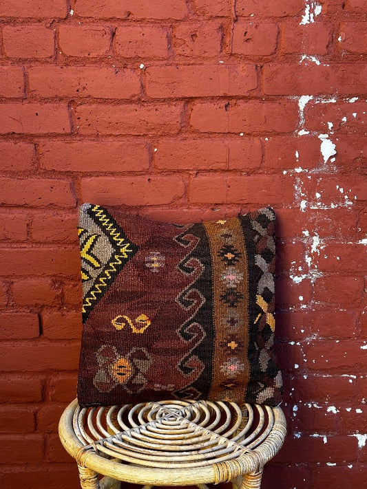 15 by 15 Turkish throw pillow featuring brown and purple muted tones and geometric patterns upcycled from Turkish rug