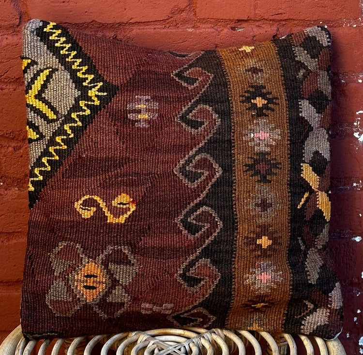 15 by 15 Turkish throw pillow featuring brown and purple muted tones and geometric patterns upcycled from Turkish rug