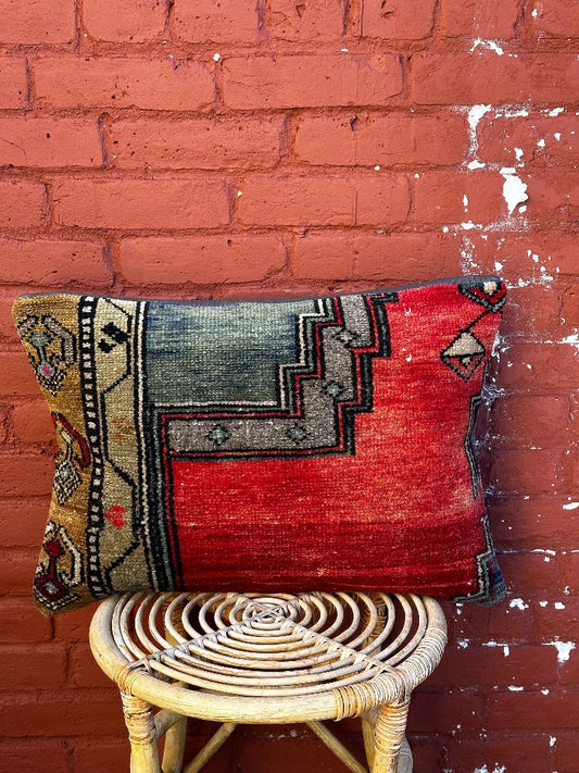 16 by 24 Turkish lumbar pillow featuring bright red coloring and accents of emerald and gold upcycled from a Turkish rug