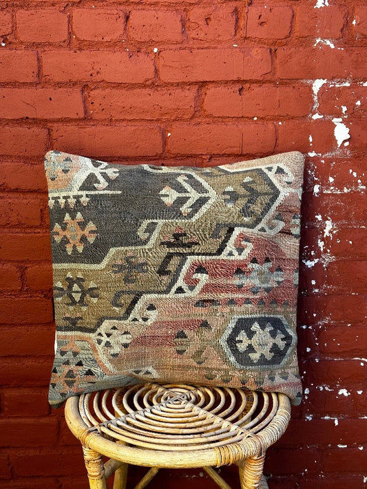 20 by 20 Turkish throw pillow featuring muted tones of blue and pink with geometric patterns upcycled from Turkish rug