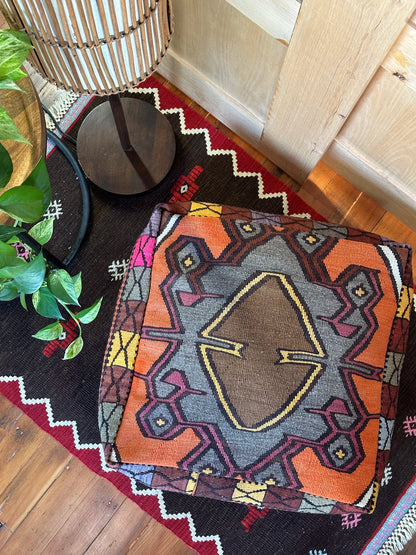 Handmade vintage Turkish rug pouf with colorful tones and a large central medallion, up-cycled from authentic wool Kilim rugs. Perfect as a unique bohemian floor cushion, ottoman, or accent seating for living rooms, bedrooms, or cozy spaces. Ethically crafted by artisans in Turkey.