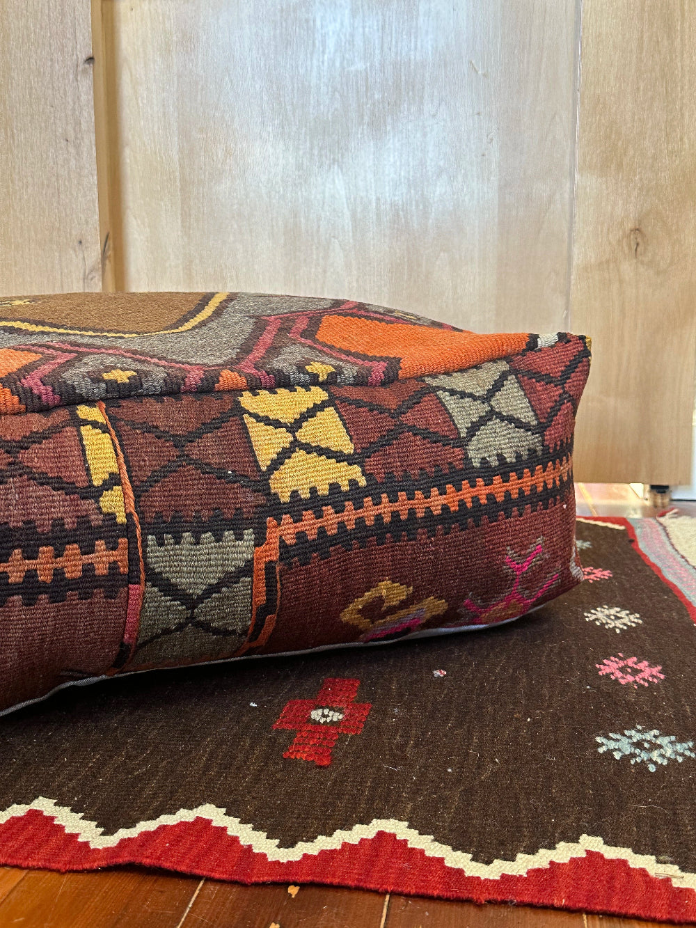 Handmade vintage Turkish rug pouf with colorful tones and a large central medallion, up-cycled from authentic wool Kilim rugs. Perfect as a unique bohemian floor cushion, ottoman, or accent seating for living rooms, bedrooms, or cozy spaces. Ethically crafted by artisans in Turkey.