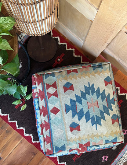 Handmade vintage Turkish rug pouf with blue & neutral tones, up-cycled from authentic wool Kilim rugs. Perfect as a unique bohemian floor cushion, ottoman, or accent seating for living rooms, bedrooms, or cozy spaces. Ethically crafted by artisans in Turkey.