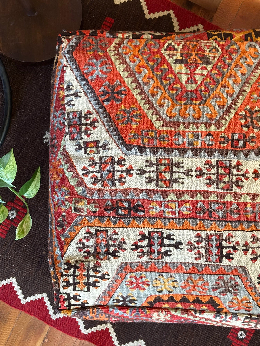 Handmade vintage Turkish rug pouf with red and orange tones, up-cycled from authentic wool Kilim rugs. Perfect as a unique bohemian floor cushion, ottoman, or accent seating for living rooms, bedrooms, or cozy spaces. Ethically crafted by artisans in Turkey.