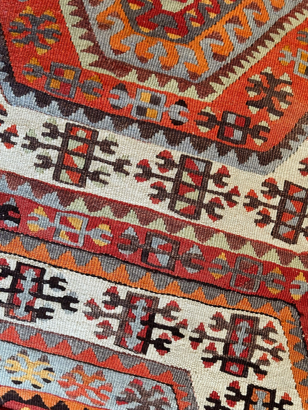 Handmade vintage Turkish rug pouf with red and orange tones, up-cycled from authentic wool Kilim rugs. Perfect as a unique bohemian floor cushion, ottoman, or accent seating for living rooms, bedrooms, or cozy spaces. Ethically crafted by artisans in Turkey.