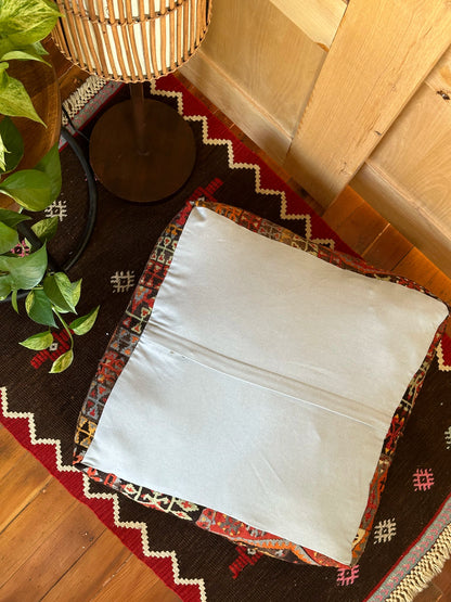 Handmade vintage Turkish rug pouf with red and orange tones, up-cycled from authentic wool Kilim rugs. Perfect as a unique bohemian floor cushion, ottoman, or accent seating for living rooms, bedrooms, or cozy spaces. Ethically crafted by artisans in Turkey.