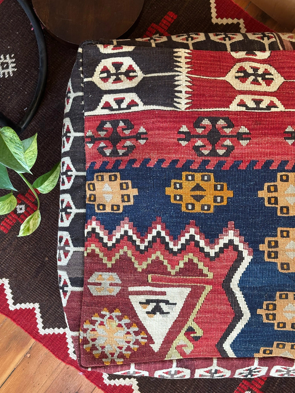 Handmade vintage Turkish rug pouf with geometric colorful tones, up-cycled from authentic wool Kilim rugs. Perfect as a unique bohemian floor cushion, ottoman, or accent seating for living rooms, bedrooms, or cozy spaces. Ethically crafted by artisans in Turkey.