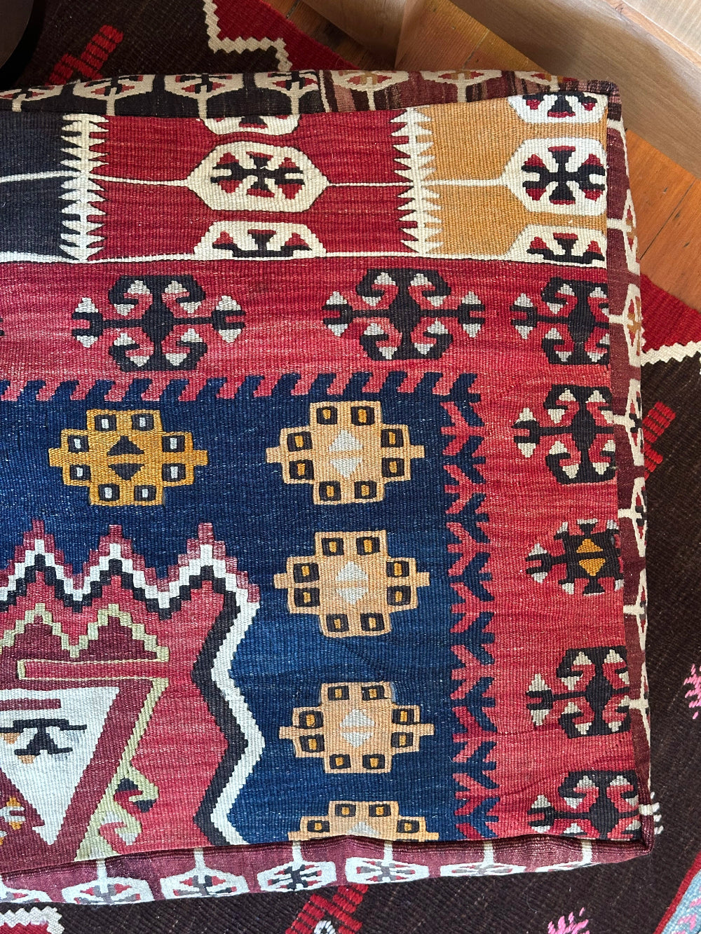 Handmade vintage Turkish rug pouf with geometric colorful tones, up-cycled from authentic wool Kilim rugs. Perfect as a unique bohemian floor cushion, ottoman, or accent seating for living rooms, bedrooms, or cozy spaces. Ethically crafted by artisans in Turkey.