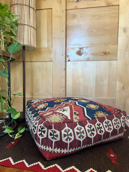 Handmade vintage Turkish rug pouf with geometric colorful tones, up-cycled from authentic wool Kilim rugs. Perfect as a unique bohemian floor cushion, ottoman, or accent seating for living rooms, bedrooms, or cozy spaces. Ethically crafted by artisans in Turkey.