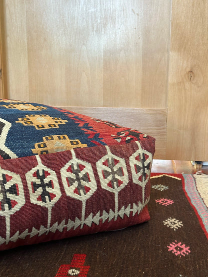 Handmade vintage Turkish rug pouf with geometric colorful tones, up-cycled from authentic wool Kilim rugs. Perfect as a unique bohemian floor cushion, ottoman, or accent seating for living rooms, bedrooms, or cozy spaces. Ethically crafted by artisans in Turkey.