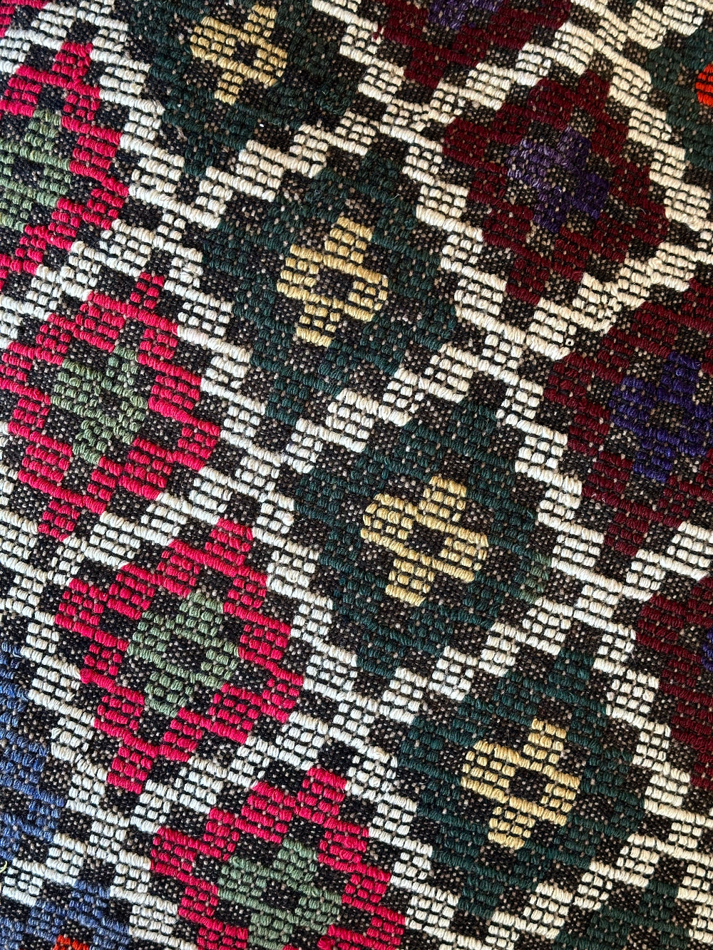 Handmade vintage Turkish rug pouf with colorful tones, up-cycled from authentic wool Kilim rugs. Perfect as a unique bohemian floor cushion, ottoman, or accent seating for living rooms, bedrooms, or cozy spaces. Ethically crafted by artisans in Turkey.