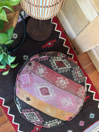 Handmade vintage Turkish rug pouf with pink and orange sunset tones, up-cycled from authentic wool Kilim rugs. Perfect as a unique bohemian floor cushion, ottoman, or accent seating for living rooms, bedrooms, or cozy spaces. Ethically crafted by artisans in Turkey.