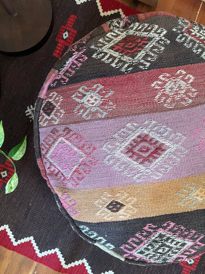 Handmade vintage Turkish rug pouf with pink and orange sunset tones, up-cycled from authentic wool Kilim rugs. Perfect as a unique bohemian floor cushion, ottoman, or accent seating for living rooms, bedrooms, or cozy spaces. Ethically crafted by artisans in Turkey.