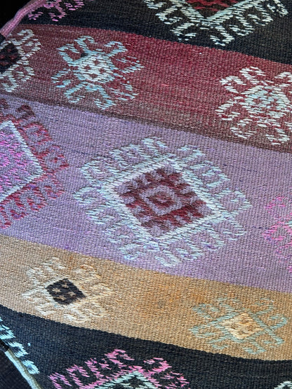 Handmade vintage Turkish rug pouf with pink and orange sunset tones, up-cycled from authentic wool Kilim rugs. Perfect as a unique bohemian floor cushion, ottoman, or accent seating for living rooms, bedrooms, or cozy spaces. Ethically crafted by artisans in Turkey.