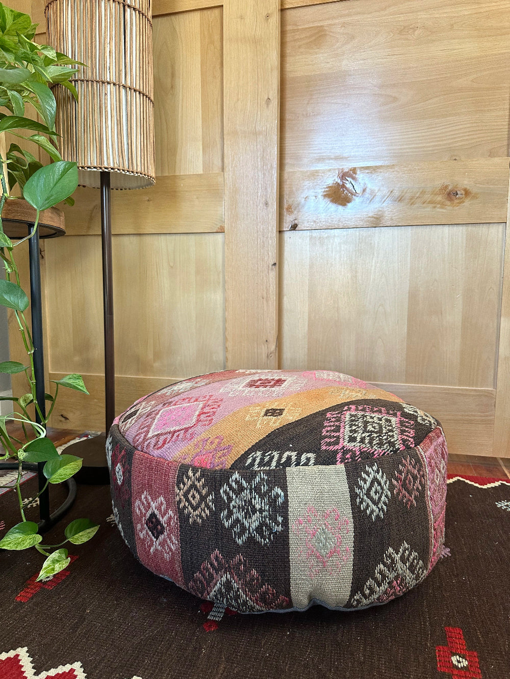 Handmade vintage Turkish rug pouf with pink and orange sunset tones, up-cycled from authentic wool Kilim rugs. Perfect as a unique bohemian floor cushion, ottoman, or accent seating for living rooms, bedrooms, or cozy spaces. Ethically crafted by artisans in Turkey.