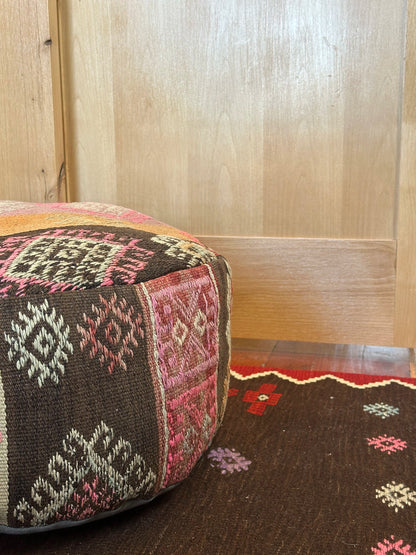 Handmade vintage Turkish rug pouf with pink and orange sunset tones, up-cycled from authentic wool Kilim rugs. Perfect as a unique bohemian floor cushion, ottoman, or accent seating for living rooms, bedrooms, or cozy spaces. Ethically crafted by artisans in Turkey.