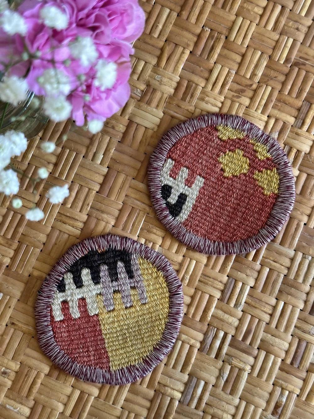 Set of 2 Turkish rug coasters made from old rugs and pillows, measuring 3.75 inches in diameter and featuring a colorful geometric pattern