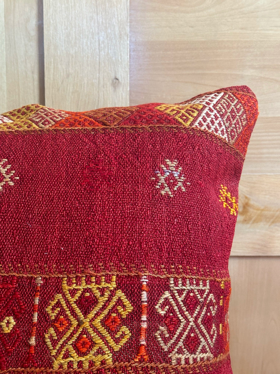 Handwoven red embroidered Turkish throw pillow, 26x26 inches, wool front with geometric design and pops of yellow and white, cotton backing—boho home decor.