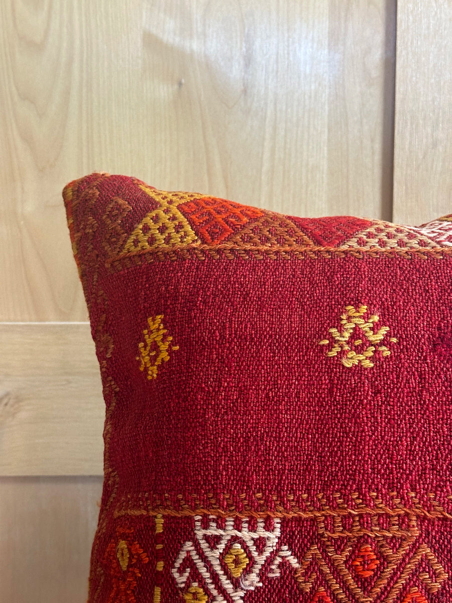 Handwoven red embroidered Turkish throw pillow, 26x26 inches, wool front with geometric design and pops of yellow and white, cotton backing—boho home decor.