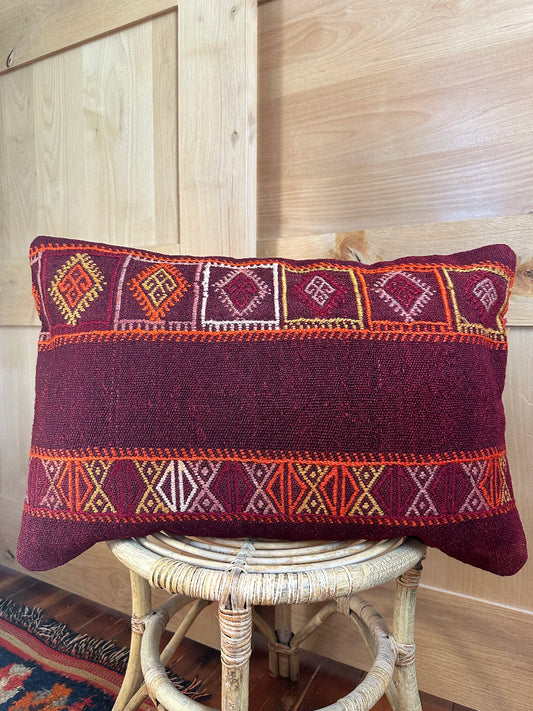 Handwoven red and orange Turkish lumbar pillow, 16x24 inches, wool front with geometric design and pops of white, cotton backing—boho home decor.