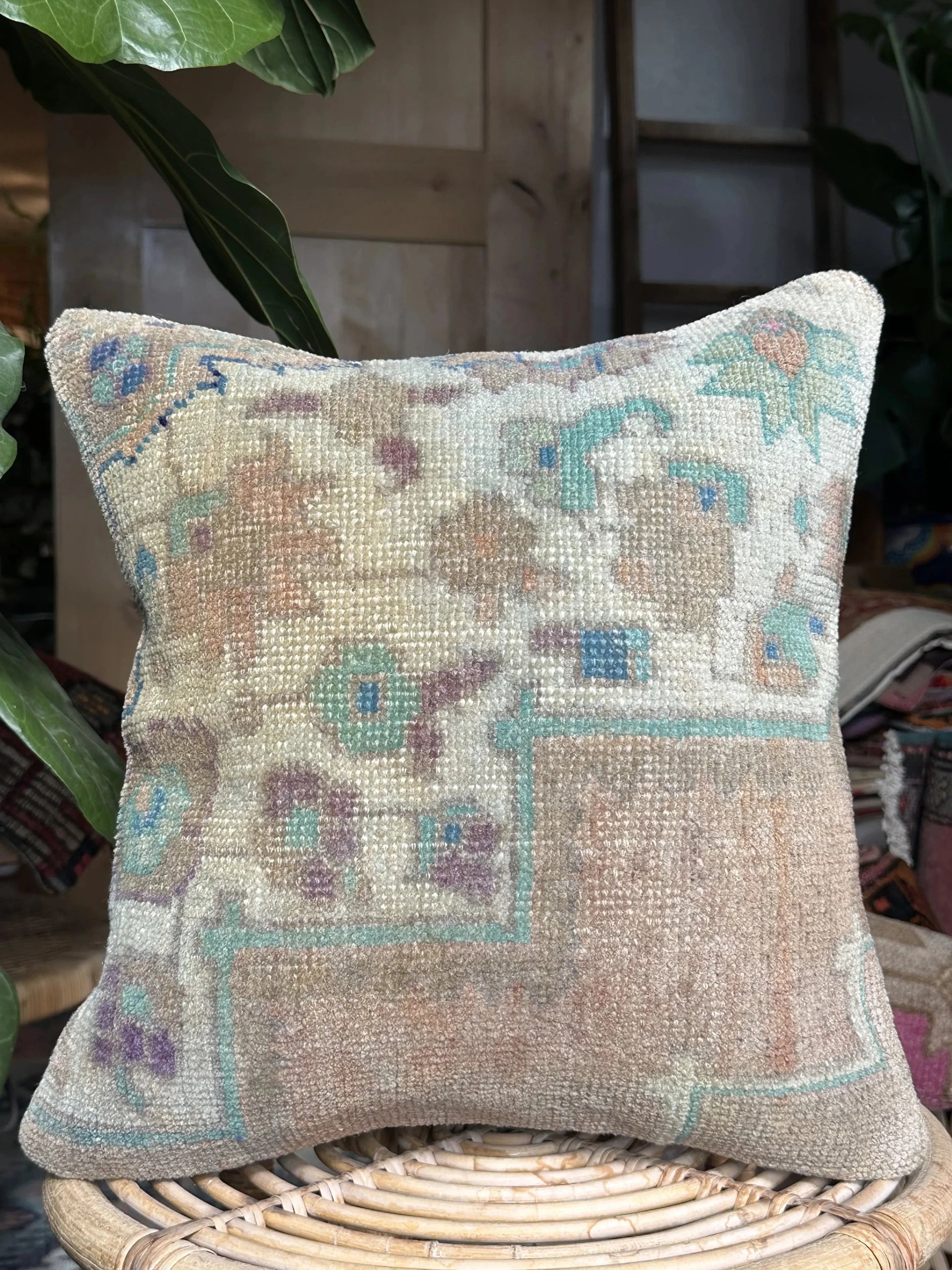 15 by 15 neutral Turkish throw pillow featuring soft pile and muted blue and white tones and a floral pattern upcycled from a Turkish rug