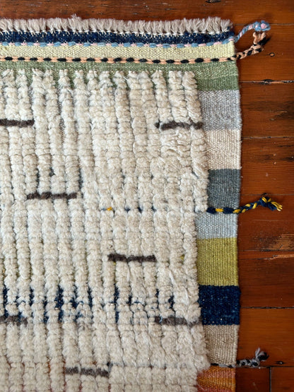 Hand-knotted mini Moroccan rug with a plush high-pile texture. Crafted from 100% wool, featuring a minimalist yet timeless design, perfect for modern, bohemian, or eclectic home décor.