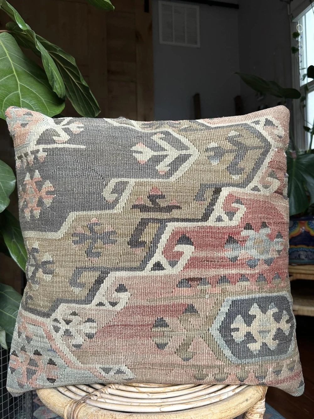 20 by 20 Turkish throw pillow featuring muted tones of blue and pink with geometric patterns upcycled from Turkish rug