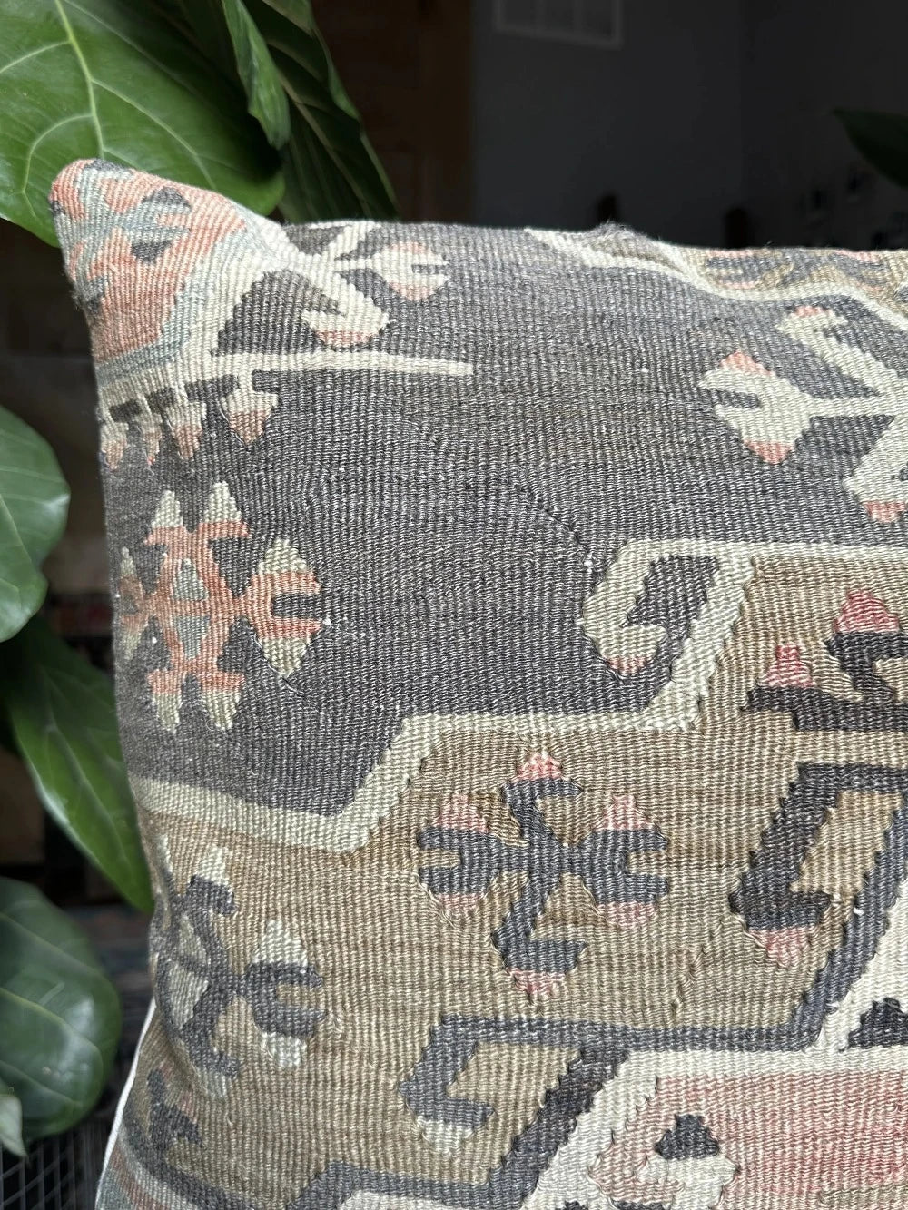 20 by 20 Turkish throw pillow featuring muted tones of blue and pink with geometric patterns upcycled from Turkish rug