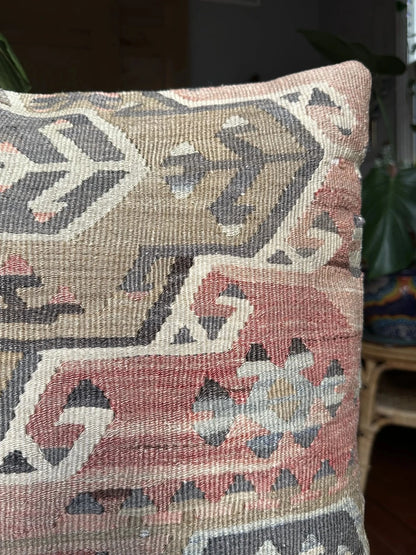 20 by 20 Turkish throw pillow featuring muted tones of blue and pink with geometric patterns upcycled from Turkish rug