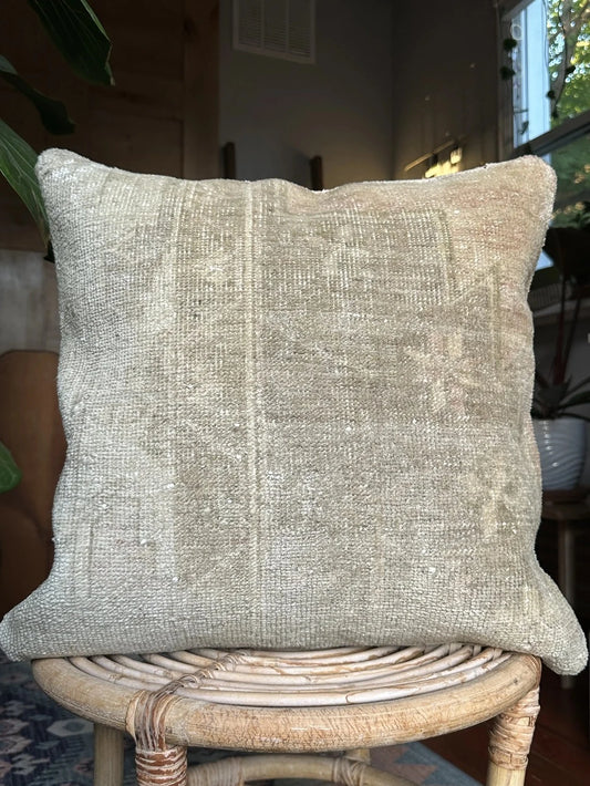 18 by 18 neutral Turkish pillow made from old Turkish rugs, light red and pink coloring throughout but mostly white and light sand