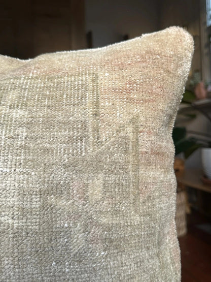 18 by 18 neutral Turkish pillow made from old Turkish rugs, light red and pink coloring throughout but mostly white and light sand