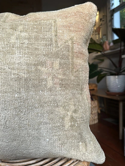 18 by 18 neutral Turkish pillow made from old Turkish rugs, light red and pink coloring throughout but mostly white and light sand
