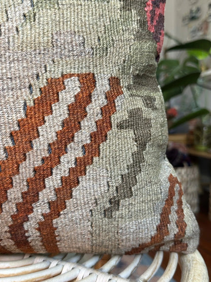 16 by 16 neutral Turkish pillow featuring a tan and brown colorway with pops of color in the form of geometric looking flowers