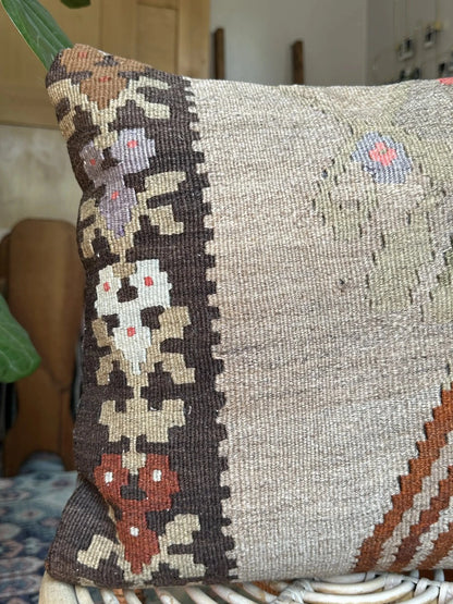 16 by 16 neutral Turkish pillow featuring a tan and brown colorway with pops of color in the form of geometric looking flowers