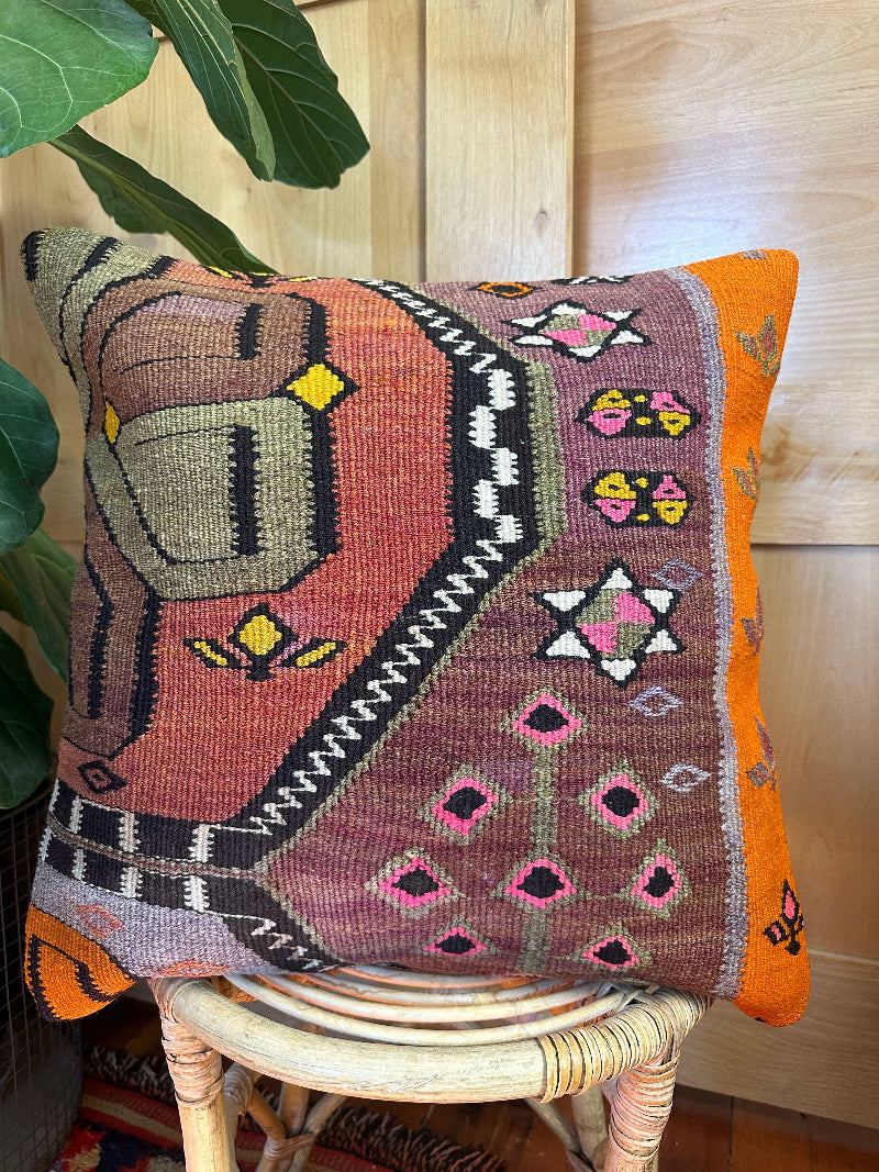 Eco-friendly handwoven kilim pillow made from upcycled vintage Turkish rugs. Artisan-crafted with bold tribal motifs in earthy and vibrant tones
