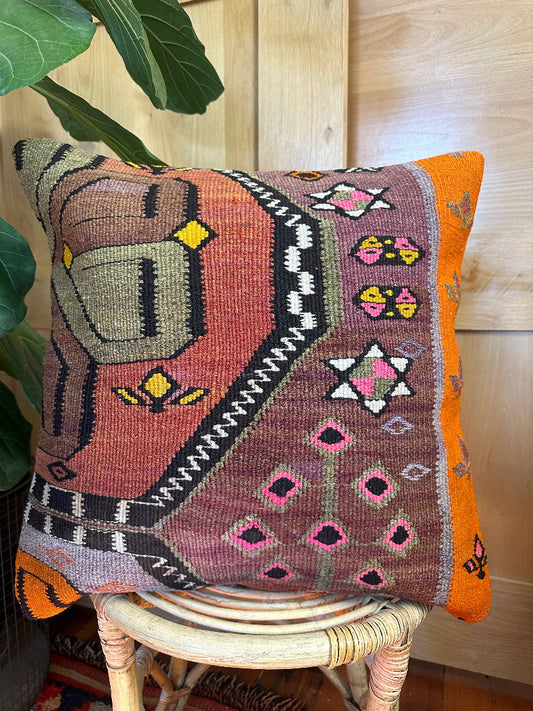 Eco-friendly handwoven kilim pillow made from upcycled vintage Turkish rugs. Artisan-crafted with bold tribal motifs in earthy and vibrant tones