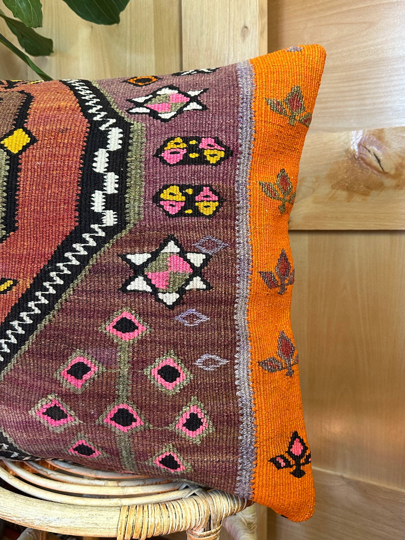 Eco-friendly handwoven kilim pillow made from upcycled vintage Turkish rugs. Artisan-crafted with bold tribal motifs in earthy and vibrant tones