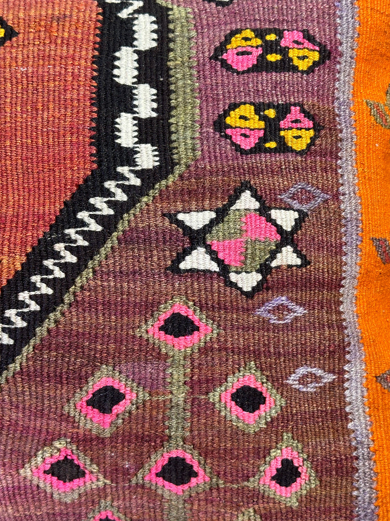 Eco-friendly handwoven kilim pillow made from upcycled vintage Turkish rugs. Artisan-crafted with bold tribal motifs in earthy and vibrant tones