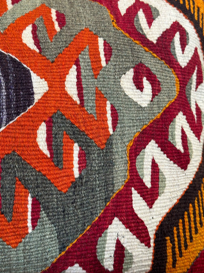 16 by 24 Decorative pillow with geometric pattern on a wooden stool indoors