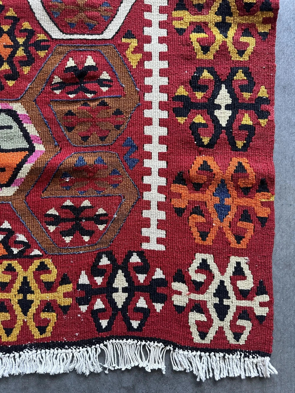 5 by 3 bright red Turkish area rug featuring floral and geometric border with pops of green, yellow, orange, perfect condition