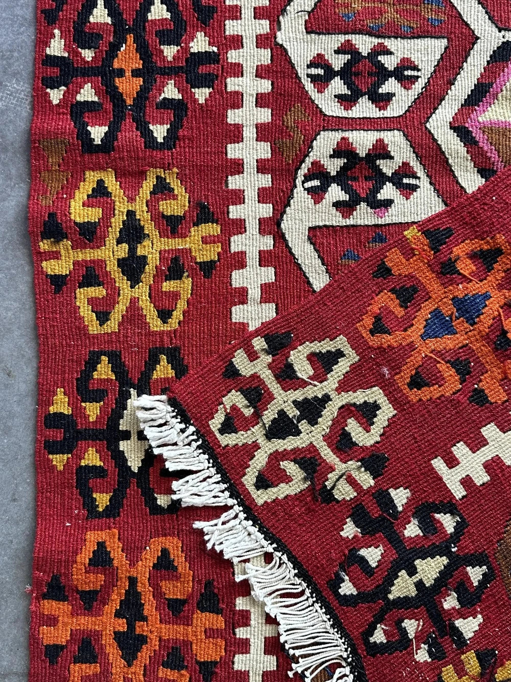 5 by 3 bright red Turkish area rug featuring floral and geometric border with pops of green, yellow, orange, perfect condition