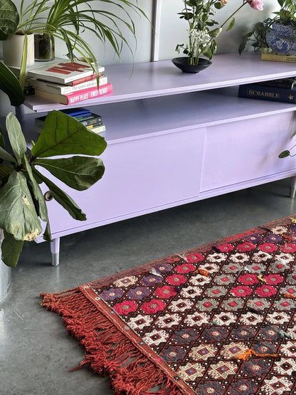 5.5 by 3.8 ft red Turkish area rug and tapestry with fringe, featuring white, pink, purple and blue 8-pointed stars