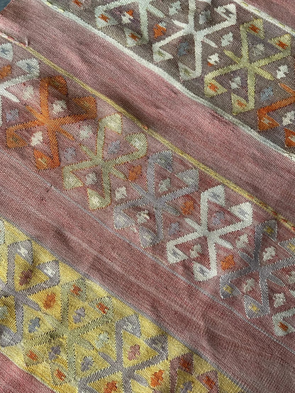 small Turkish flatwoven kilim rug featuring sunset coloring, sherbet pink and sunshine yellow and geometric striped pattern throughout