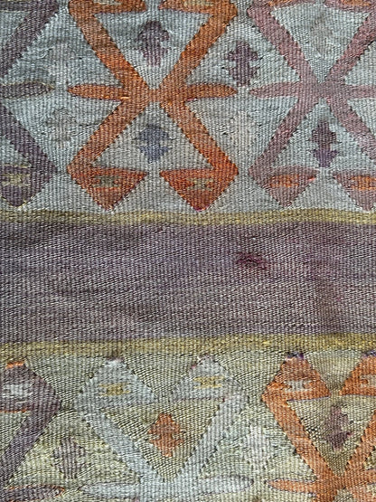 small Turkish flatwoven kilim rug featuring sunset coloring, sherbet pink and sunshine yellow and geometric striped pattern throughout