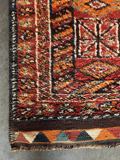 11 foot by 3 foot Turkish high pile Herki runner, featuring a black, red and orange geometric pattern throughout