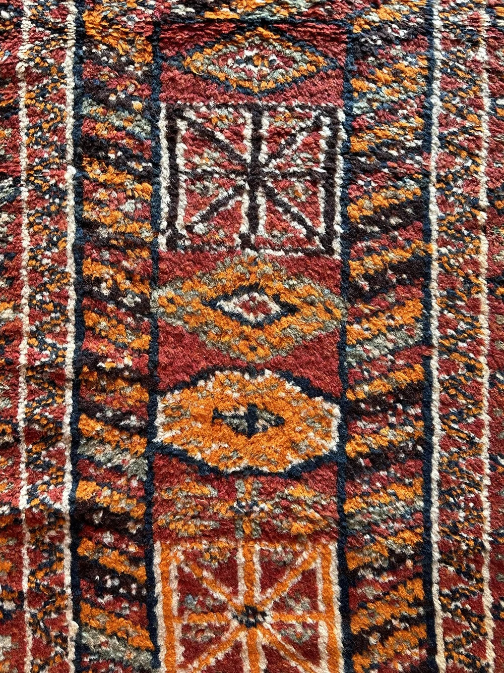 11 foot by 3 foot Turkish high pile Herki runner, featuring a black, red and orange geometric pattern throughout