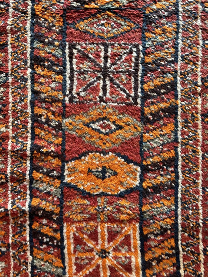 11 foot by 3 foot Turkish high pile Herki runner, featuring a black, red and orange geometric pattern throughout