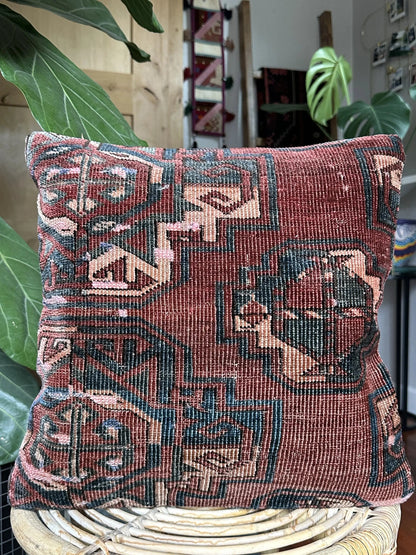 handmade Turkish throw pillow featuring a deep mauve and light pink coloring and geometric designs throughout