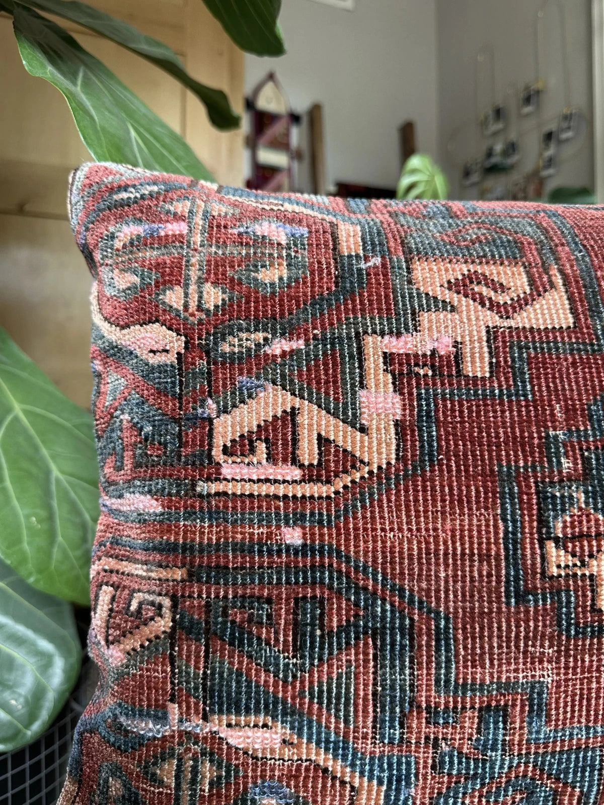 handmade Turkish throw pillow featuring a deep mauve and light pink coloring and geometric designs throughout