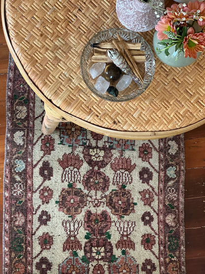 Vintage Turkish wool rug with a floral tree of life design in burgundy, green, and ivory tones, featuring a detailed border of small floral motifs.